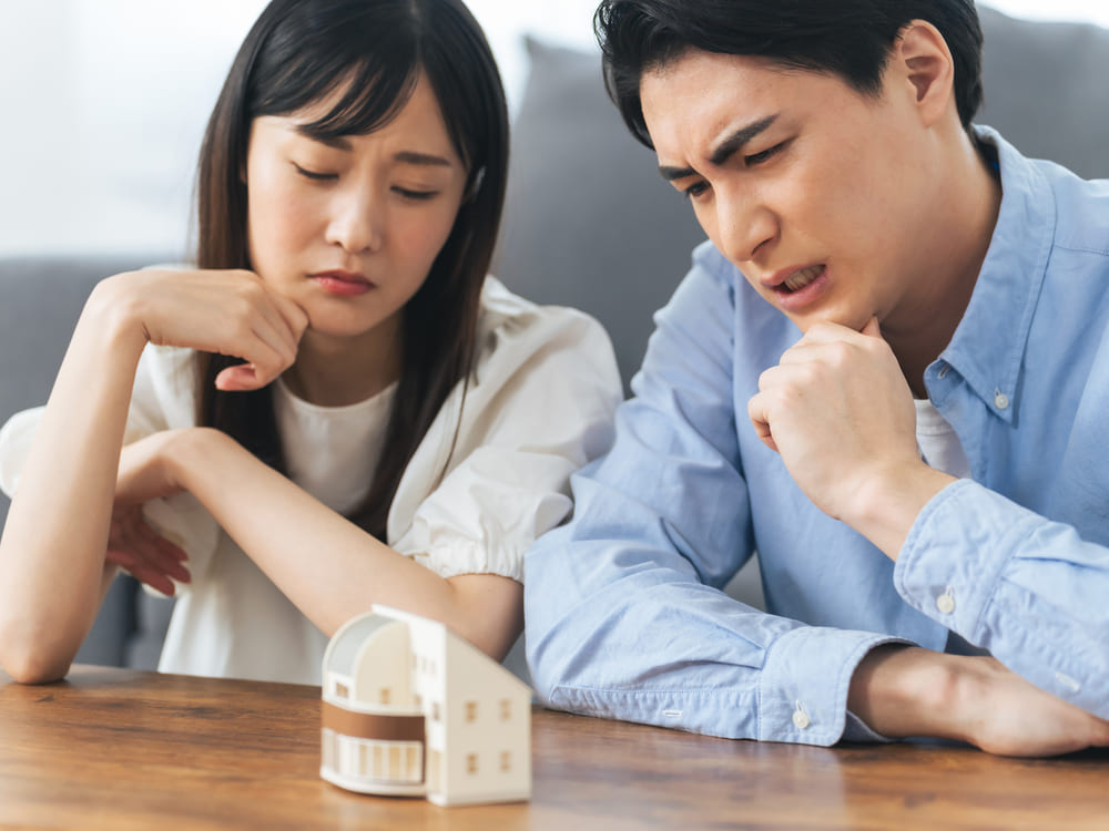 家を見て悩んでいるカップル